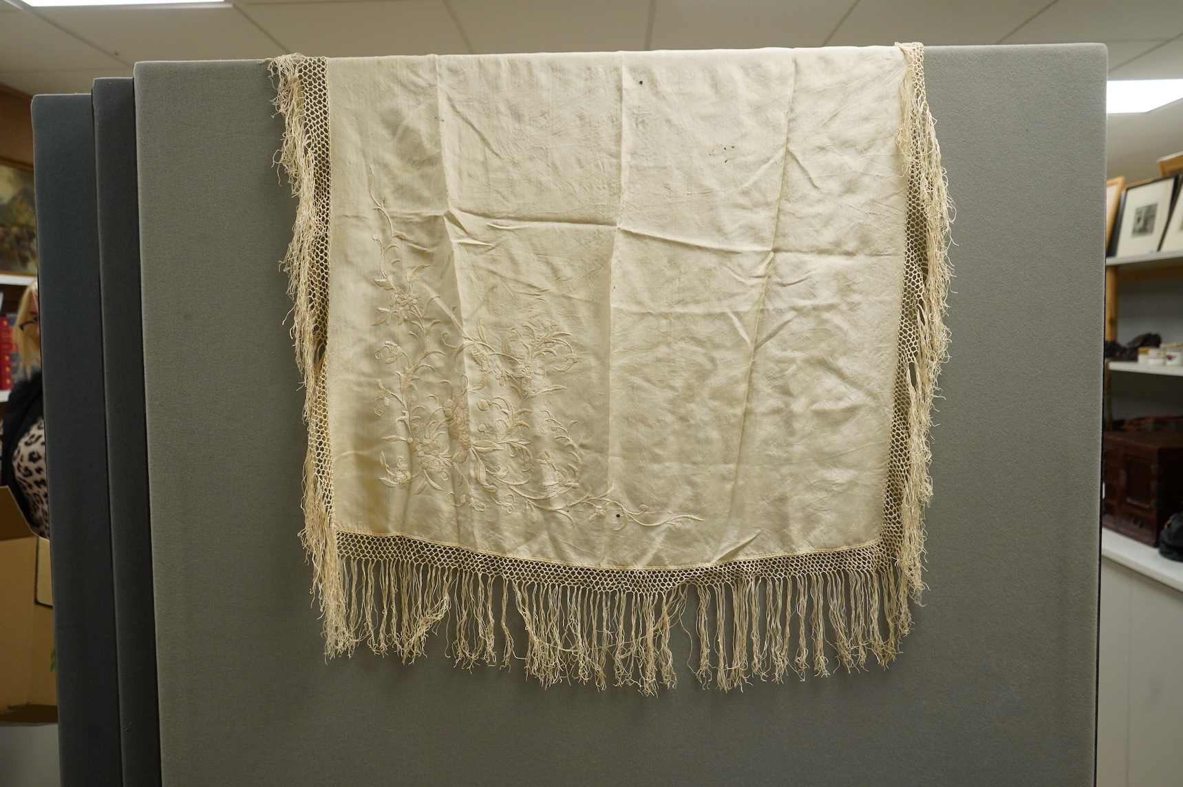 An early Chinese 20th century cream silk damask shawl with a polychrome floral silk embroidered border and a silk fringe, 150cm x 150cm, together with a smaller shawl/scarf, the corner cream on cream embroidered and edgi